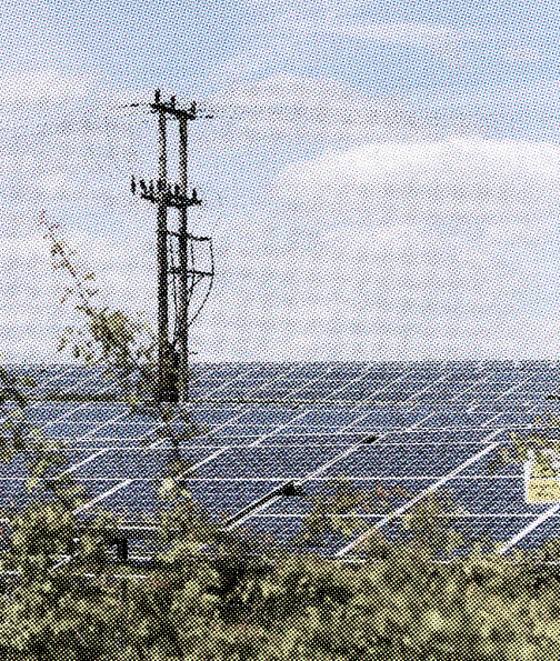 Solar array beneath an overhead power line — distributed generation meeting the grid.
